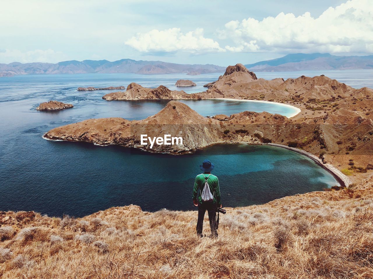 REAR VIEW OF MAN LOOKING AT VIEW OF SKY