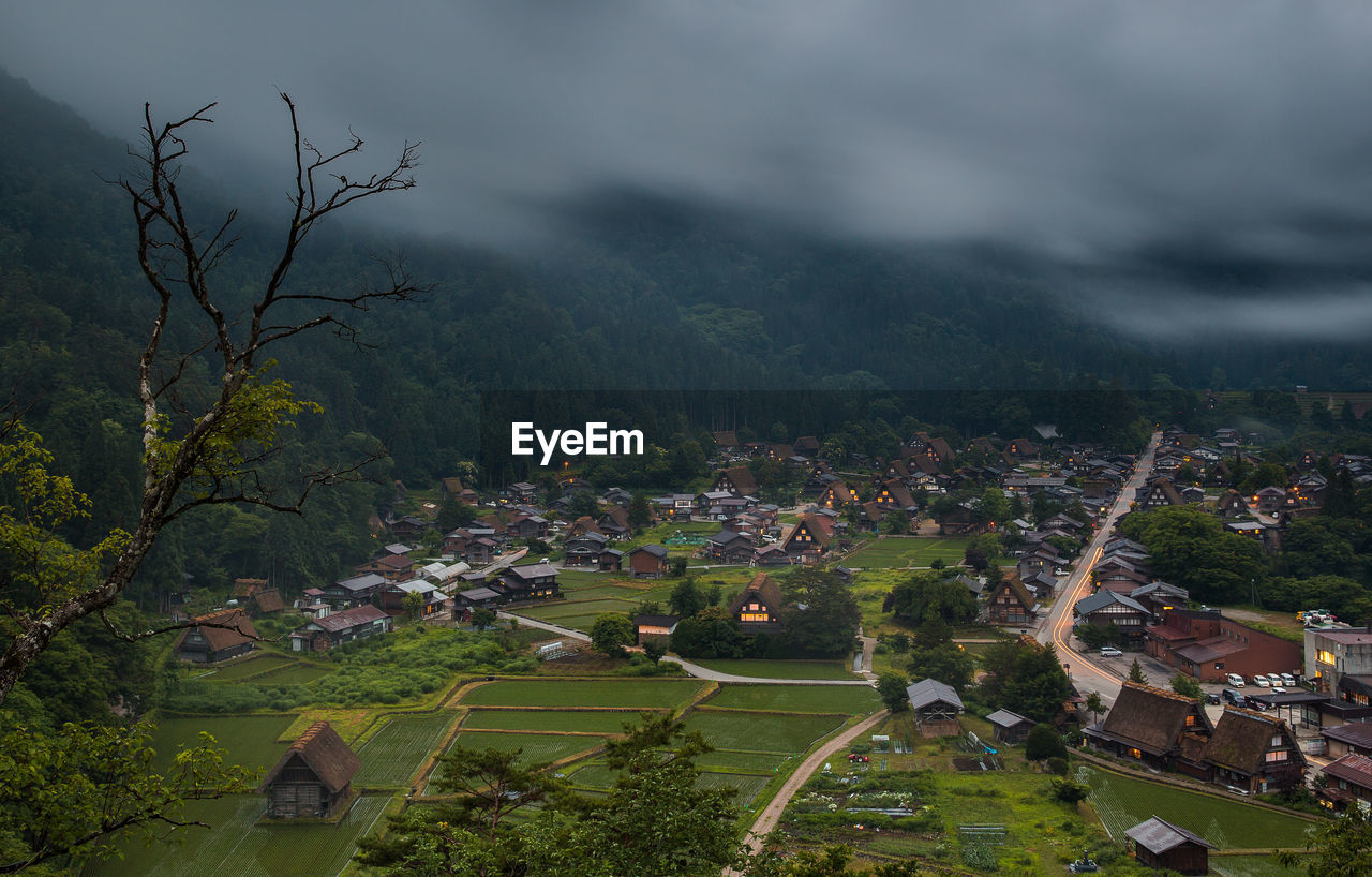 High angle view of trees and buildings against sky