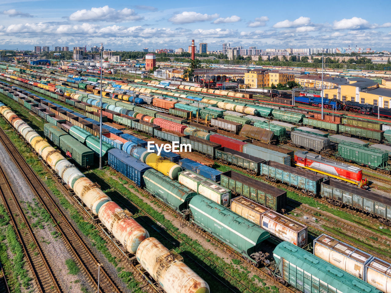 Top view on the railways with various colorful freight wagons. transportation of goods by train.