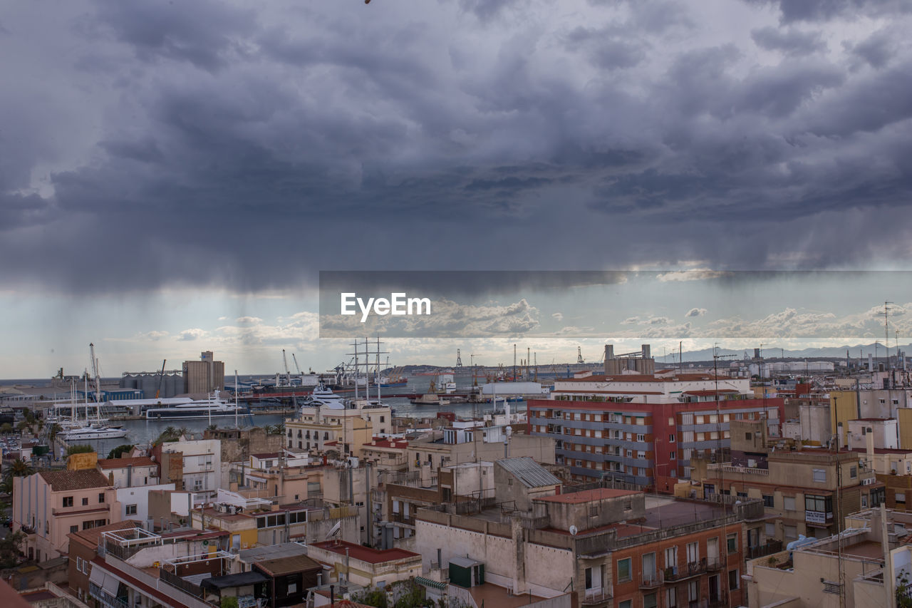 High angle view of buildings against cloudy sky