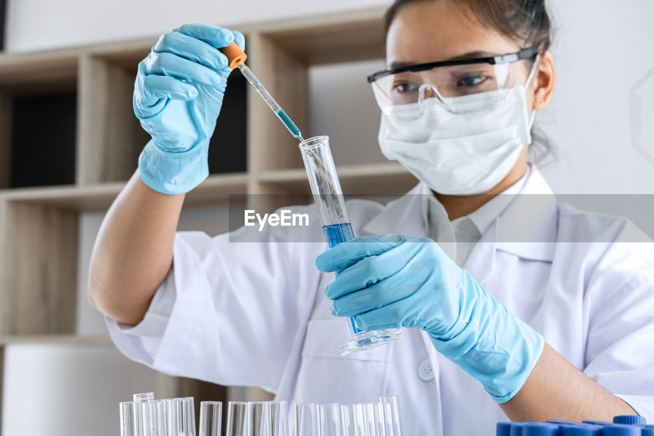 Portrait of woman holding test tube