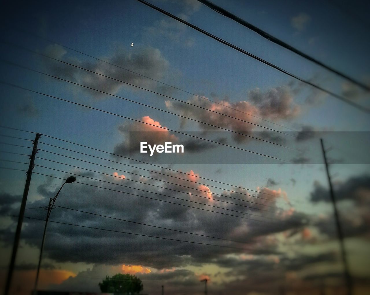 LOW ANGLE VIEW OF POWER LINES AGAINST CLOUDY SKY