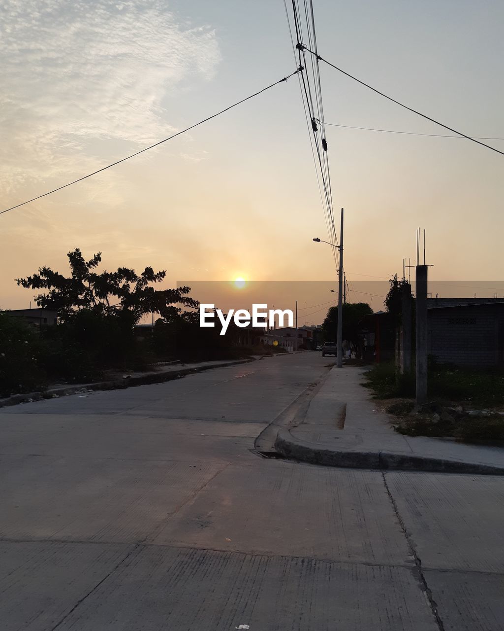 ROAD BY STREET AGAINST SKY DURING SUNSET