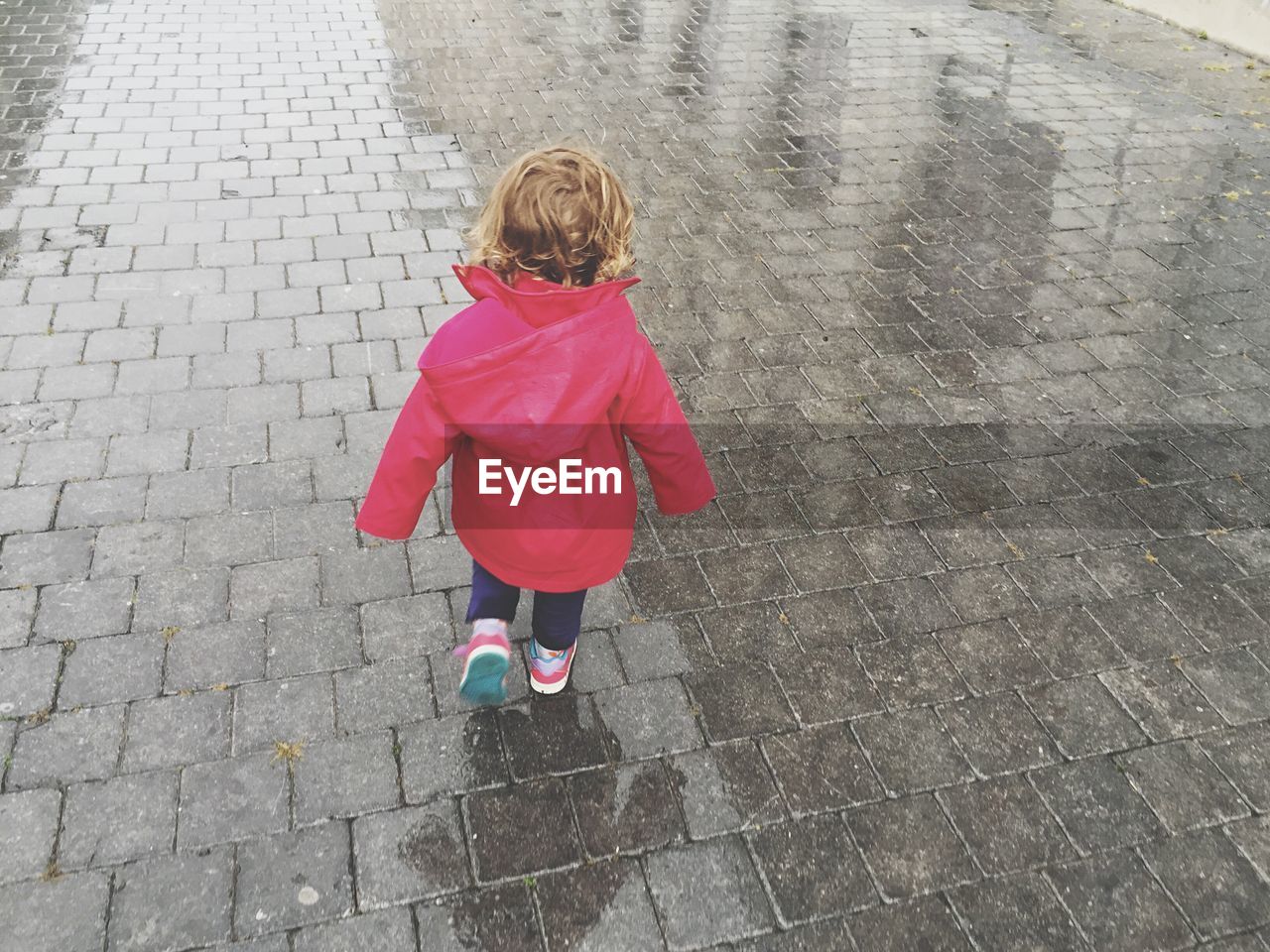 Rear view of girl wearing raincoat