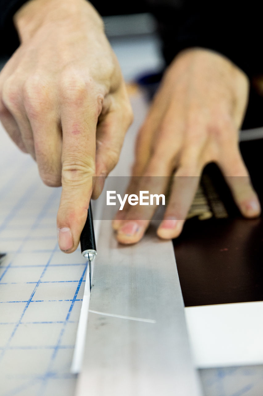 Close-up of hands with ruler