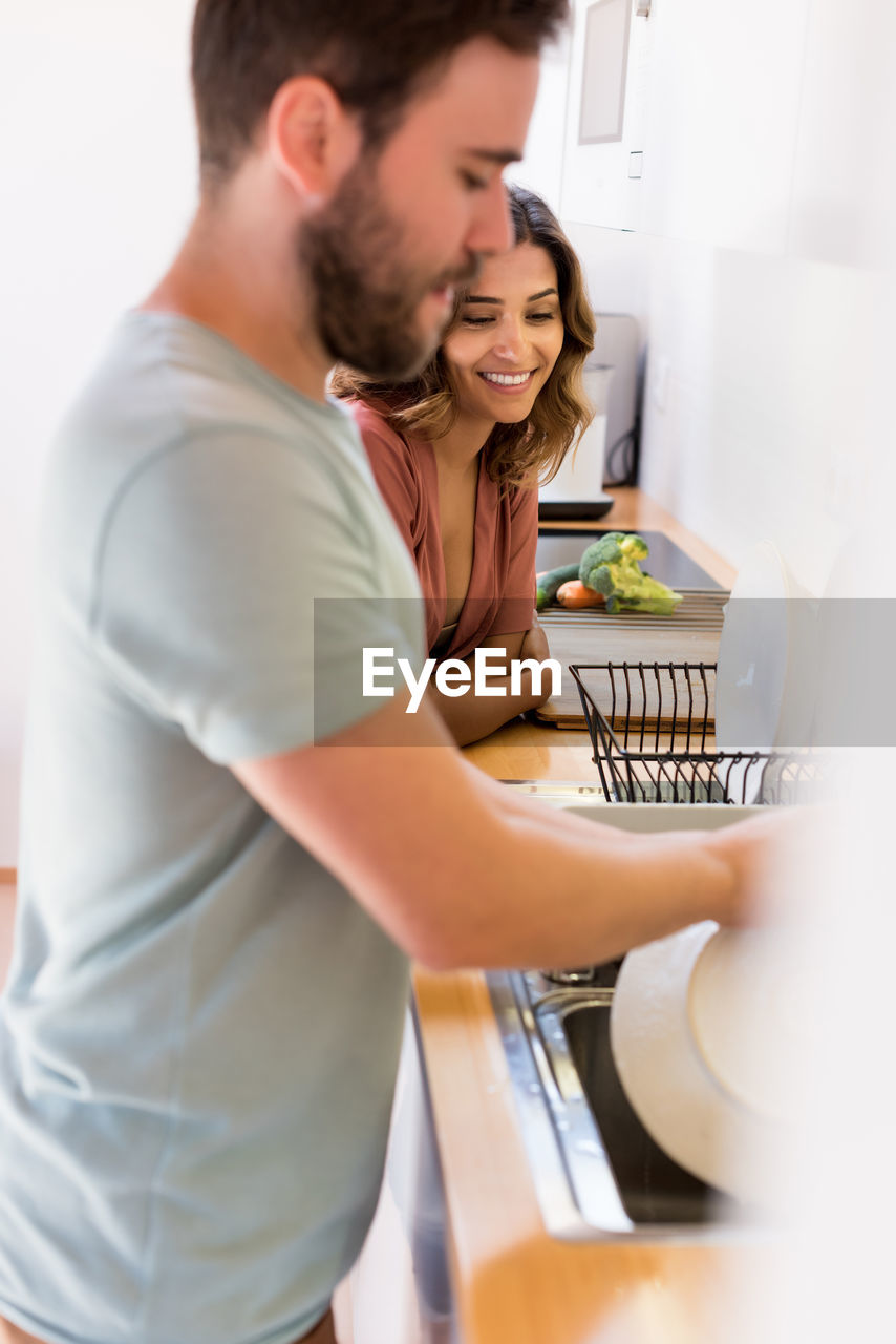 Couple standing in kitchen