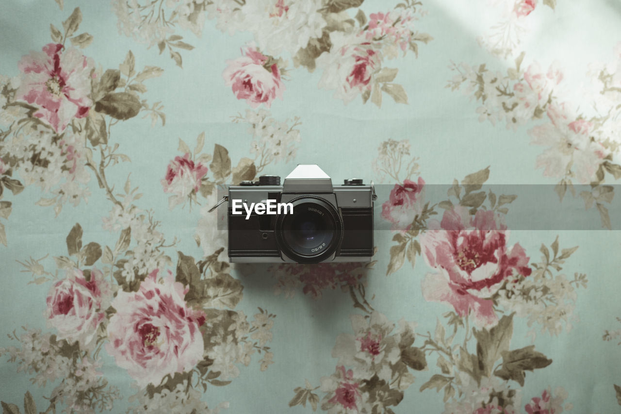 Old camera on a flowered background