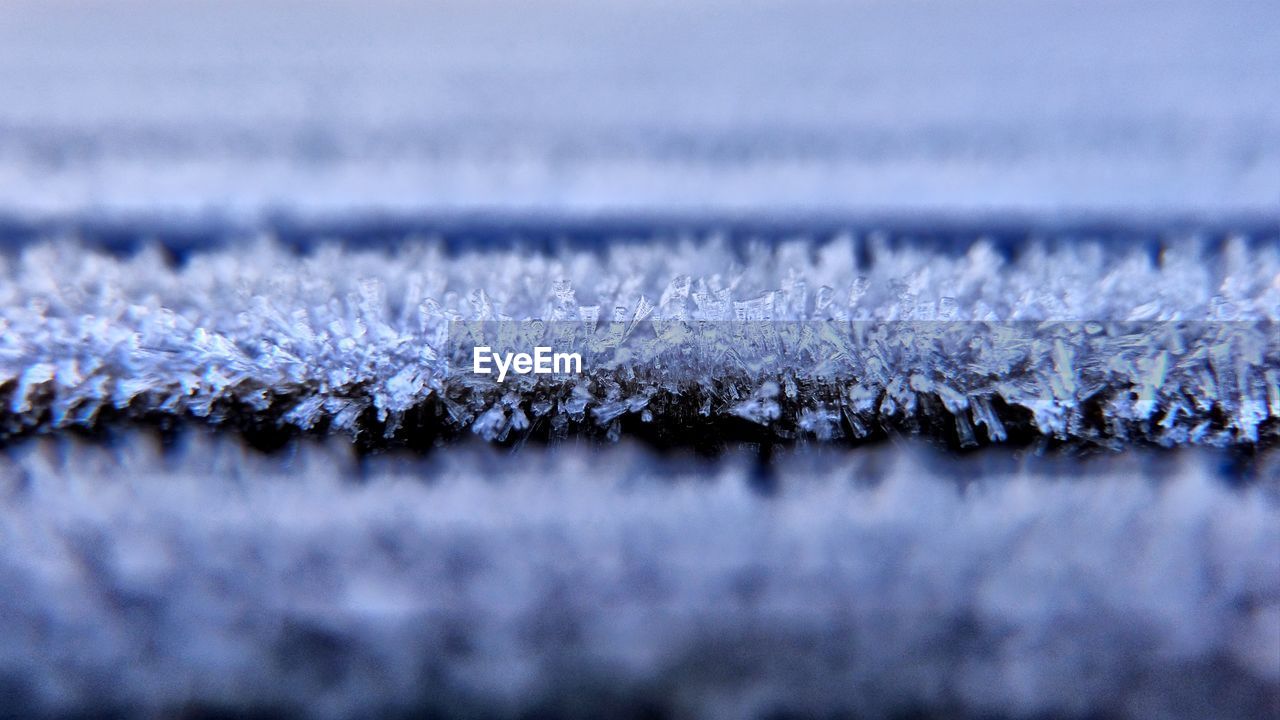 Close-up of frozen water, ripe on wooden planks