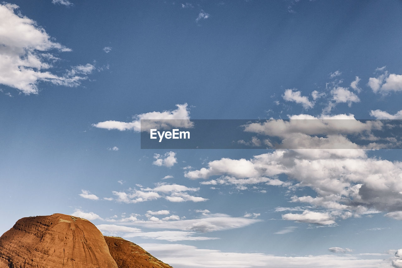 LOW ANGLE VIEW OF ROCKS AGAINST BLUE SKY