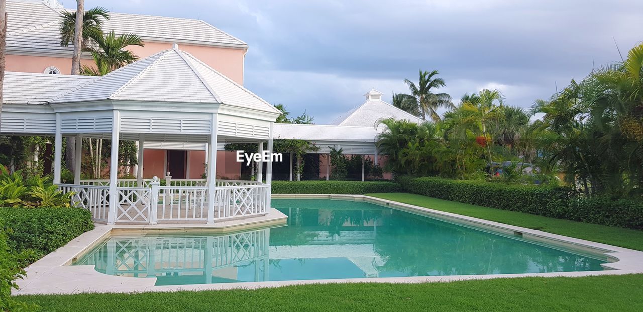 BUILDING BY SWIMMING POOL AGAINST SKY