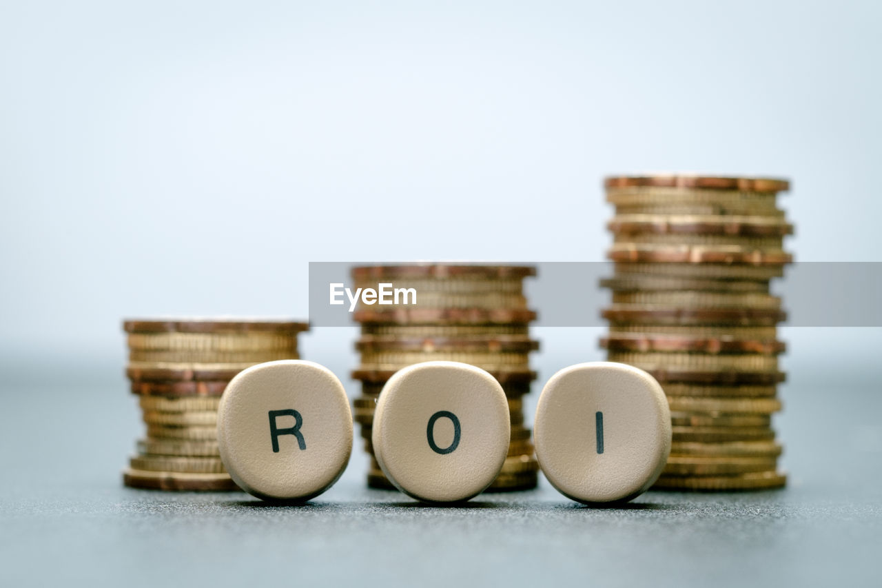 Close-up of text and coins on table against white background