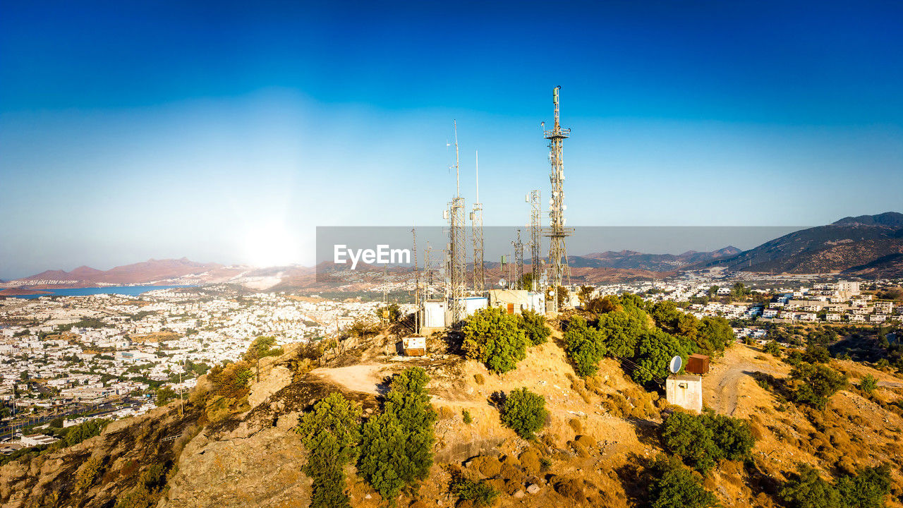 Telecommunication tower on mountin with 4g 5g cellular network antenna on city background. 