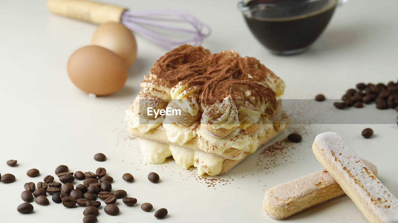 Homemade tiramisu , italian layered dessert with mascarpone cream, decorated with cocoa powder.
