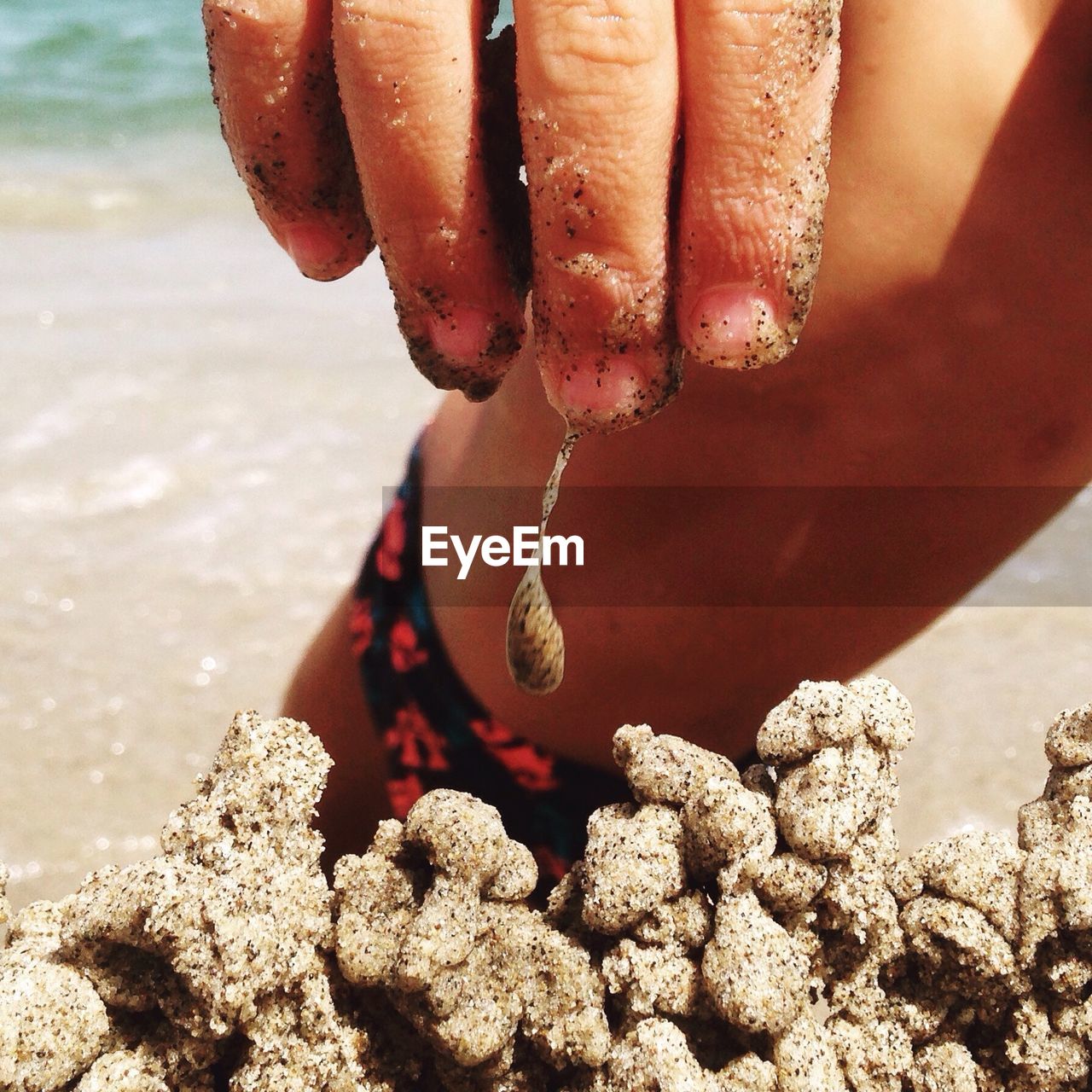 LOW SECTION OF PERSON ON BEACH