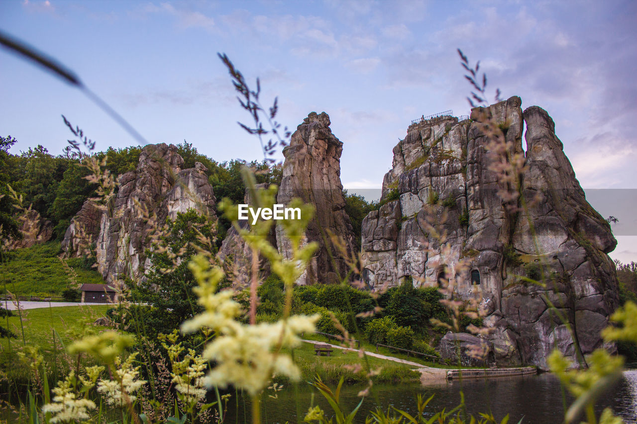 LOW ANGLE VIEW OF ROCK FORMATIONS AGAINST SKY