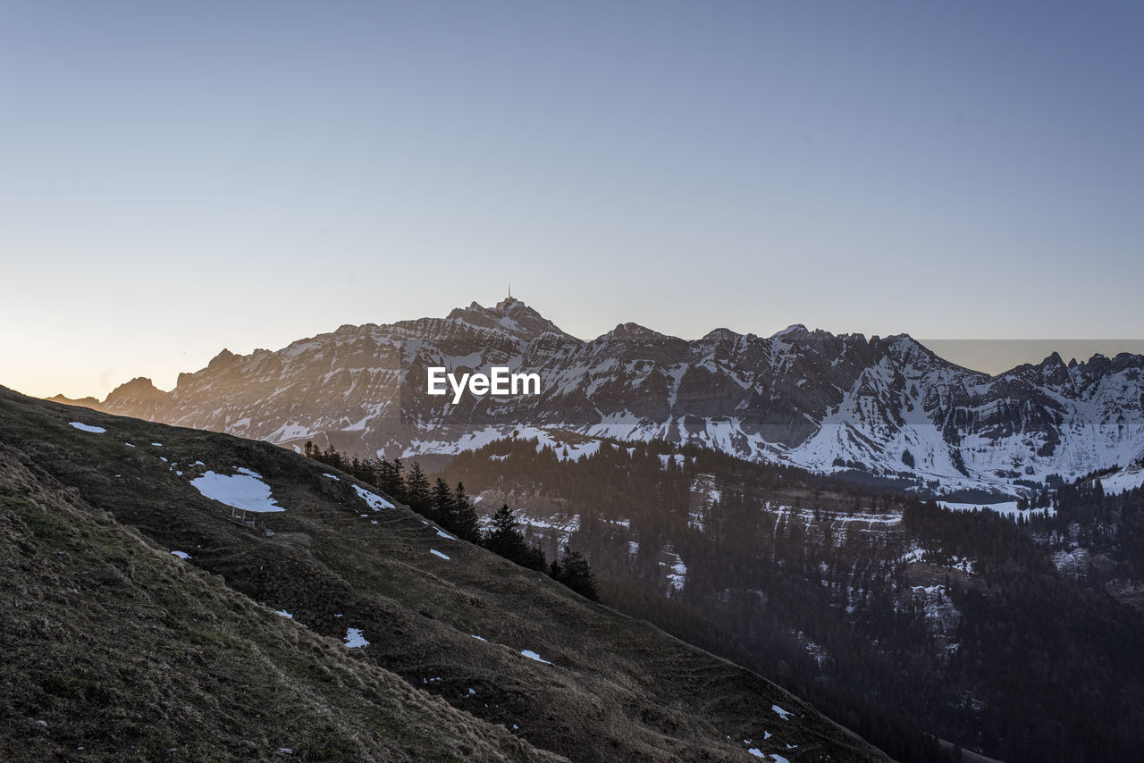 Scenic view of snowcapped mountains against clear sky