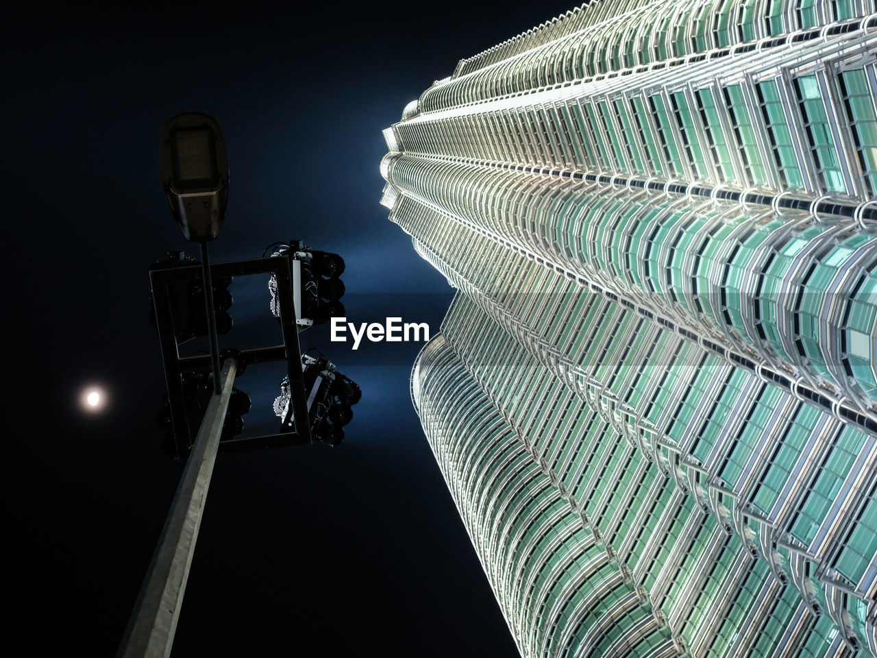 low angle view of illuminated buildings in city at night