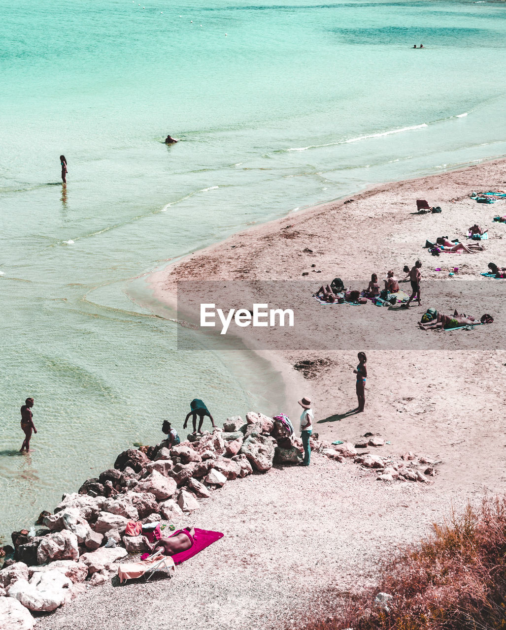 HIGH ANGLE VIEW OF PEOPLE ENJOYING AT BEACH