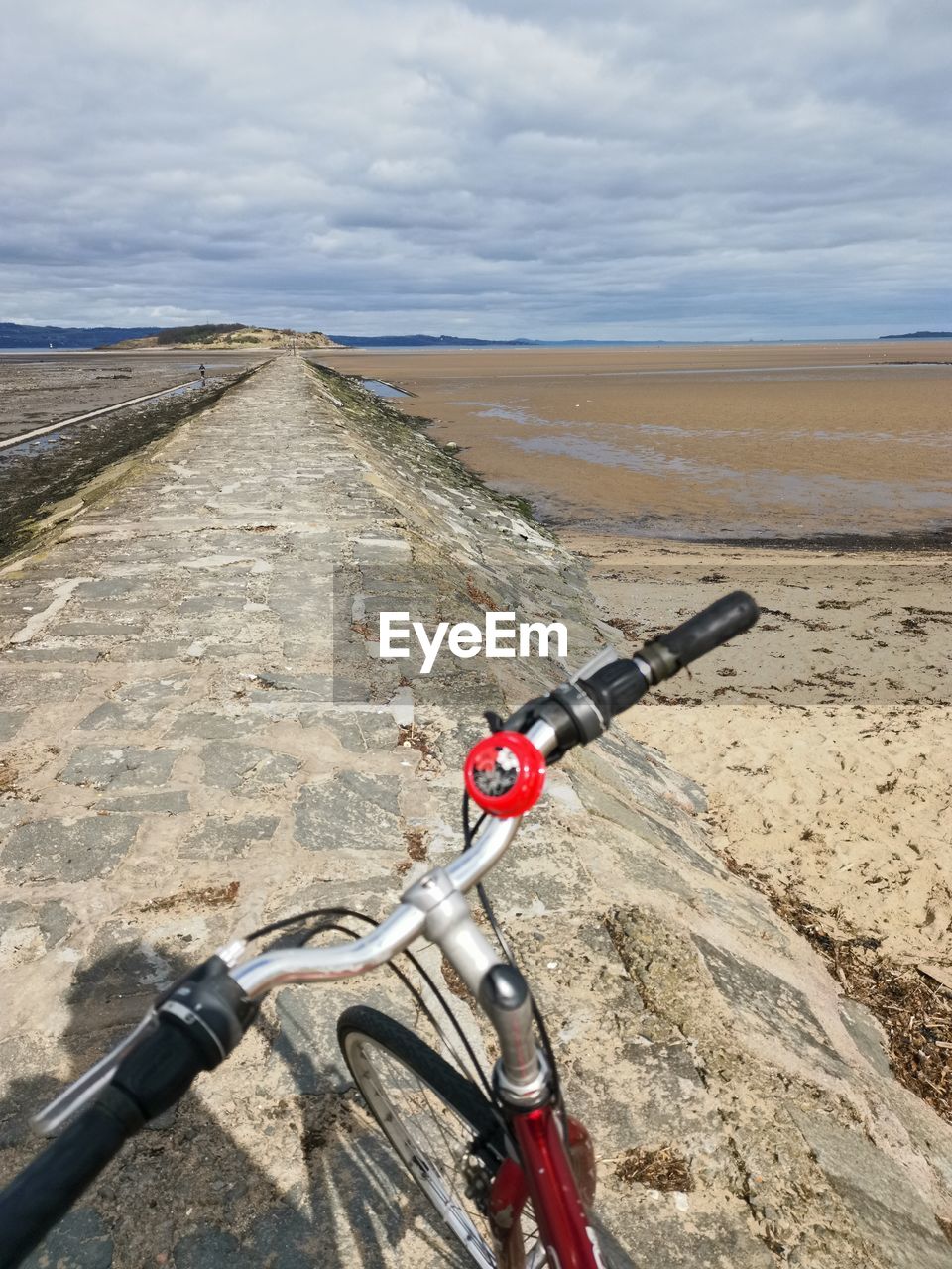 BICYCLE ON ROAD AMIDST FIELD