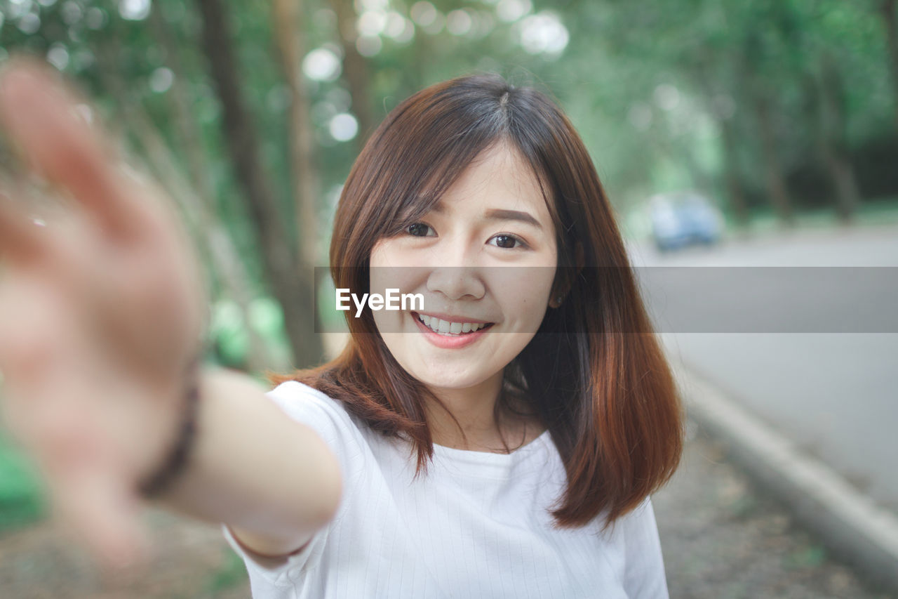 Portrait of smiling young woman in park