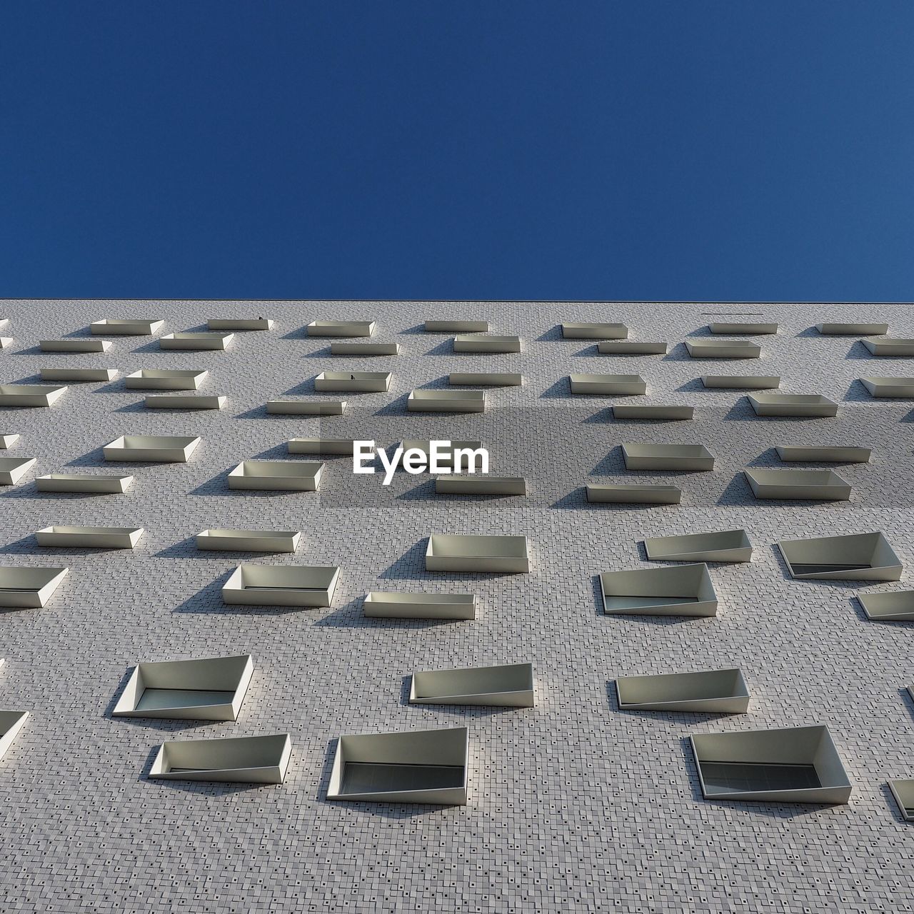 Low angle view of building against clear blue sky