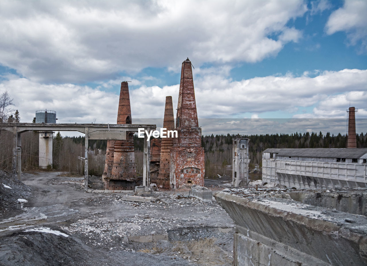 View of abandoned building against cloudy sky