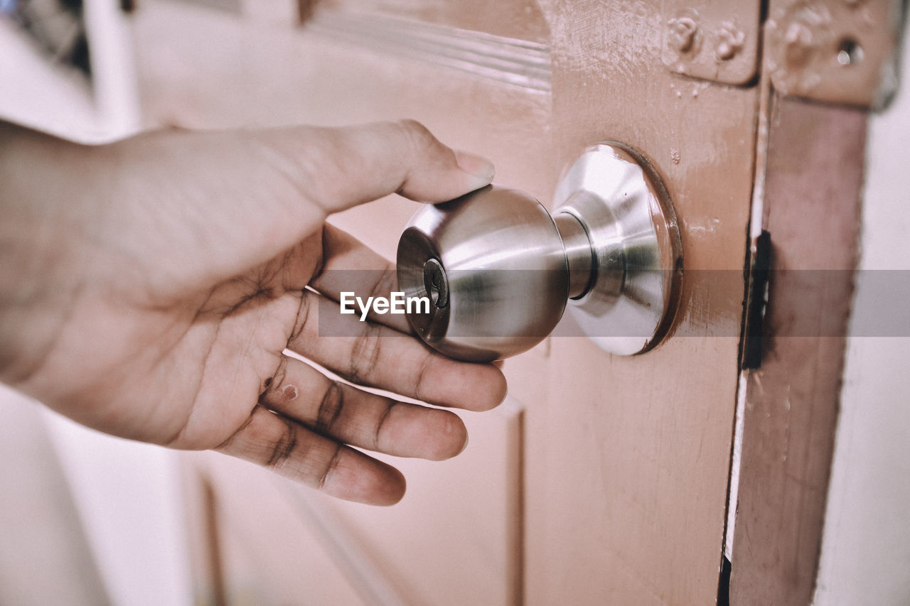 Close-up of hand holding door knob