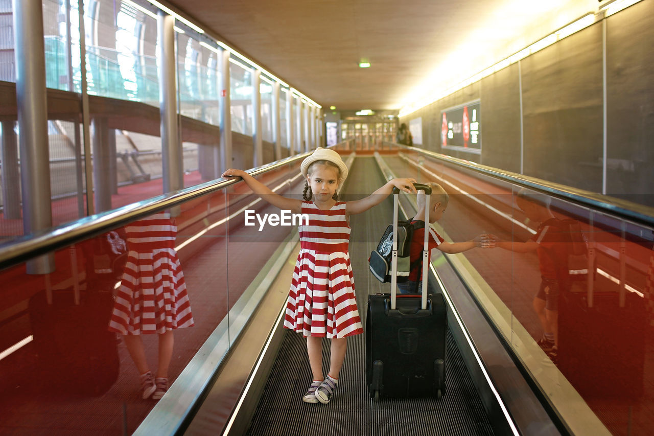 Girl standing on escalator