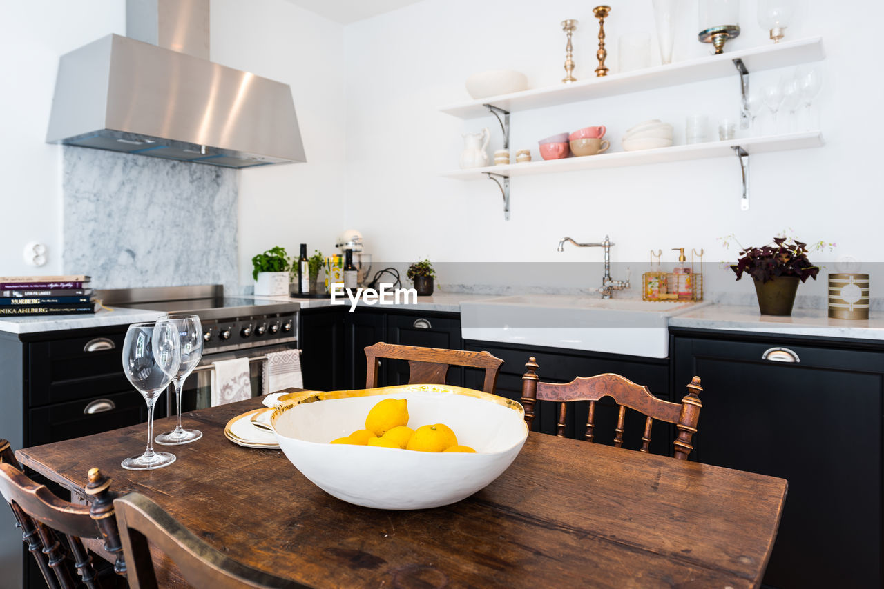 Lemons in bowl on table at home