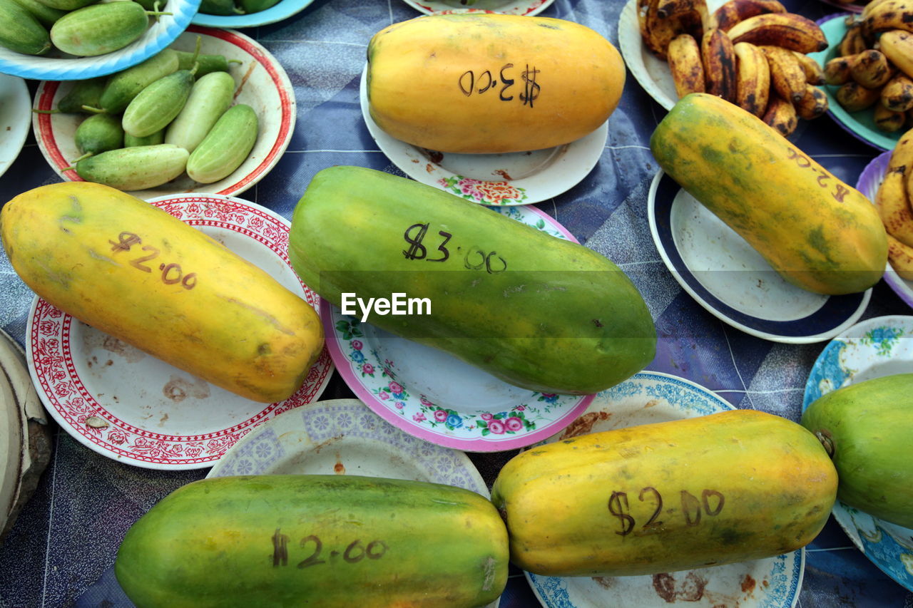 High angle view of price written on papayas for sale at market