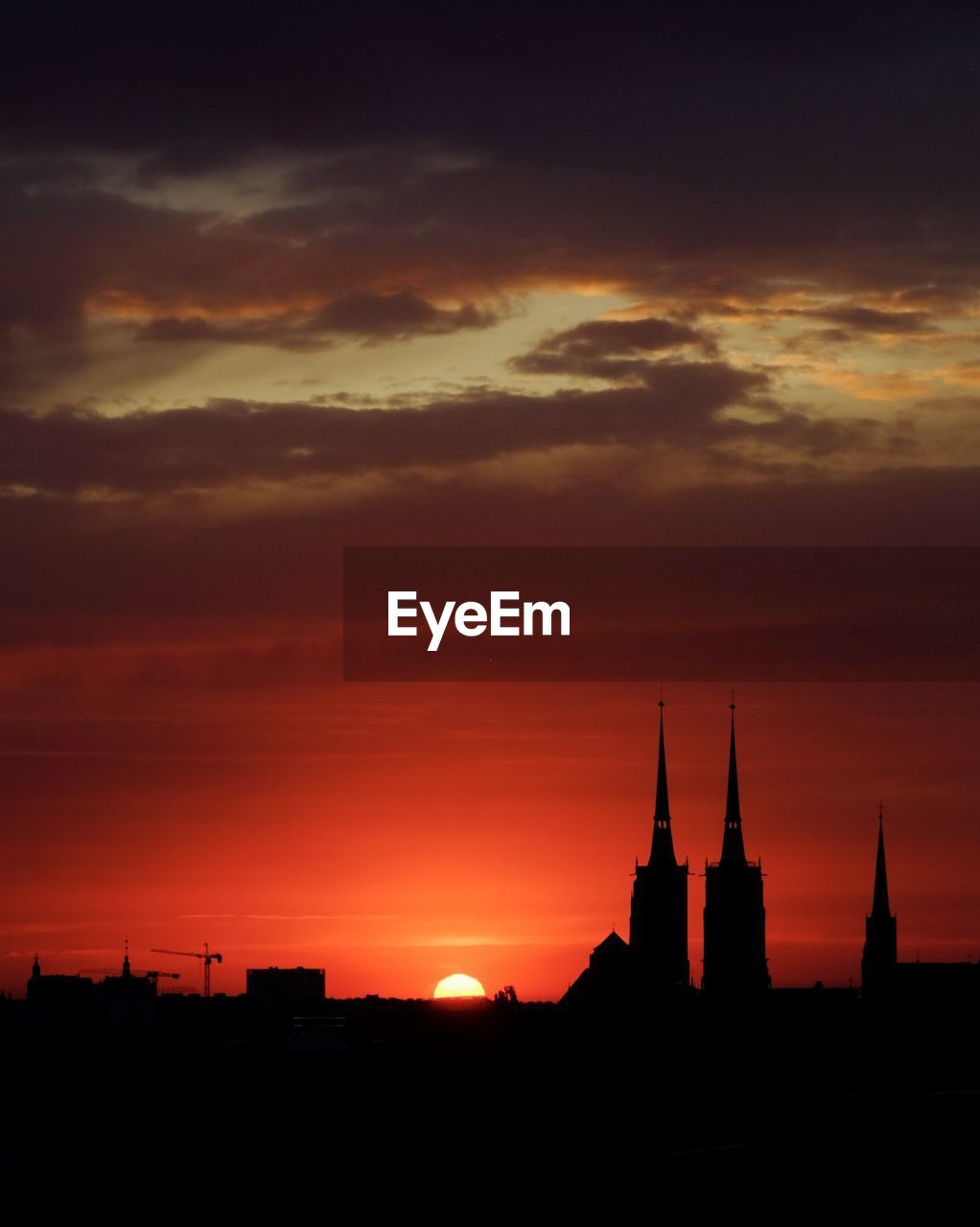 Silhouette of buildings against sky during sunset