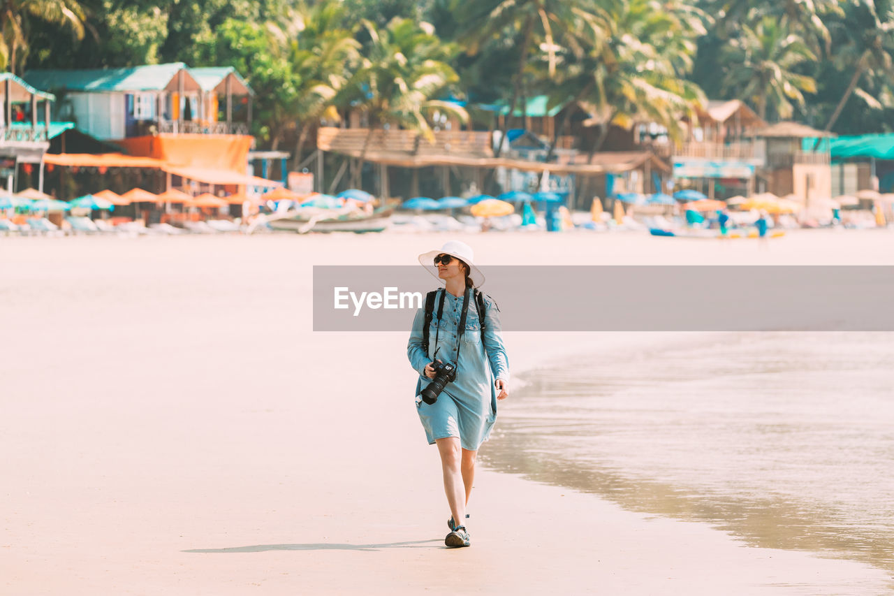 Full length of woman walking on beach