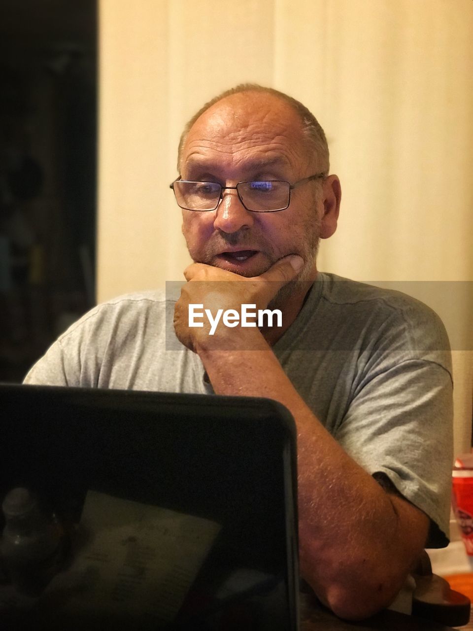 Mature man using laptop while sitting at home