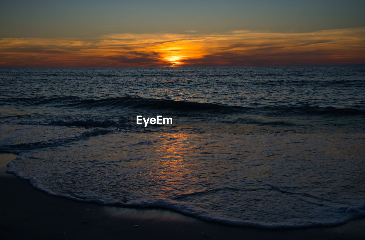 Scenic view of sea and waves against sky during sunset mystical and romantic