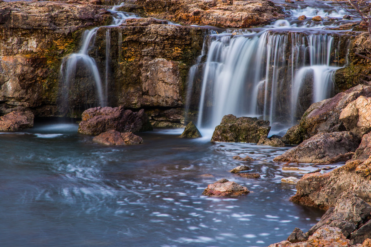 waterfall, water, scenics - nature, beauty in nature, body of water, environment, motion, rock, nature, autumn, water feature, river, stream, long exposure, flowing water, flowing, land, travel destinations, watercourse, landscape, travel, tourism, no people, forest, outdoors, blurred motion, water resources, rapid, tree, plant, non-urban scene, idyllic, speed, rock formation, sports, falling, holiday, trip, wet, vacation, splashing, social issues