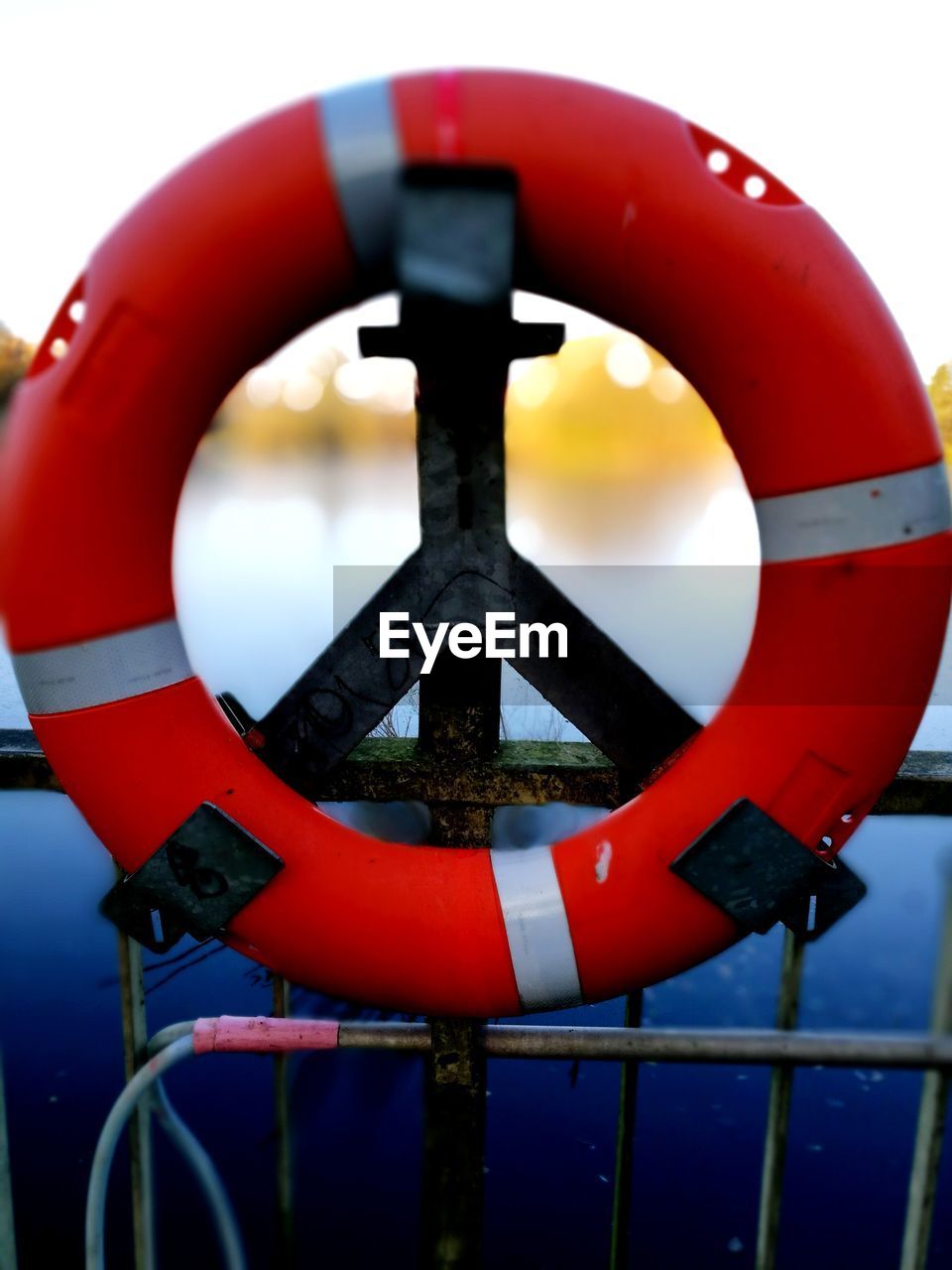 CLOSE-UP OF UMBRELLA AGAINST WATER