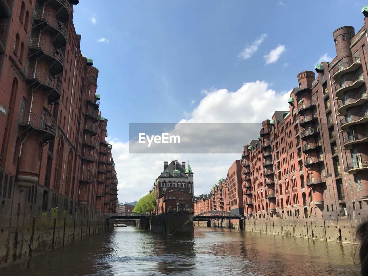 Buildings in city against cloudy sky