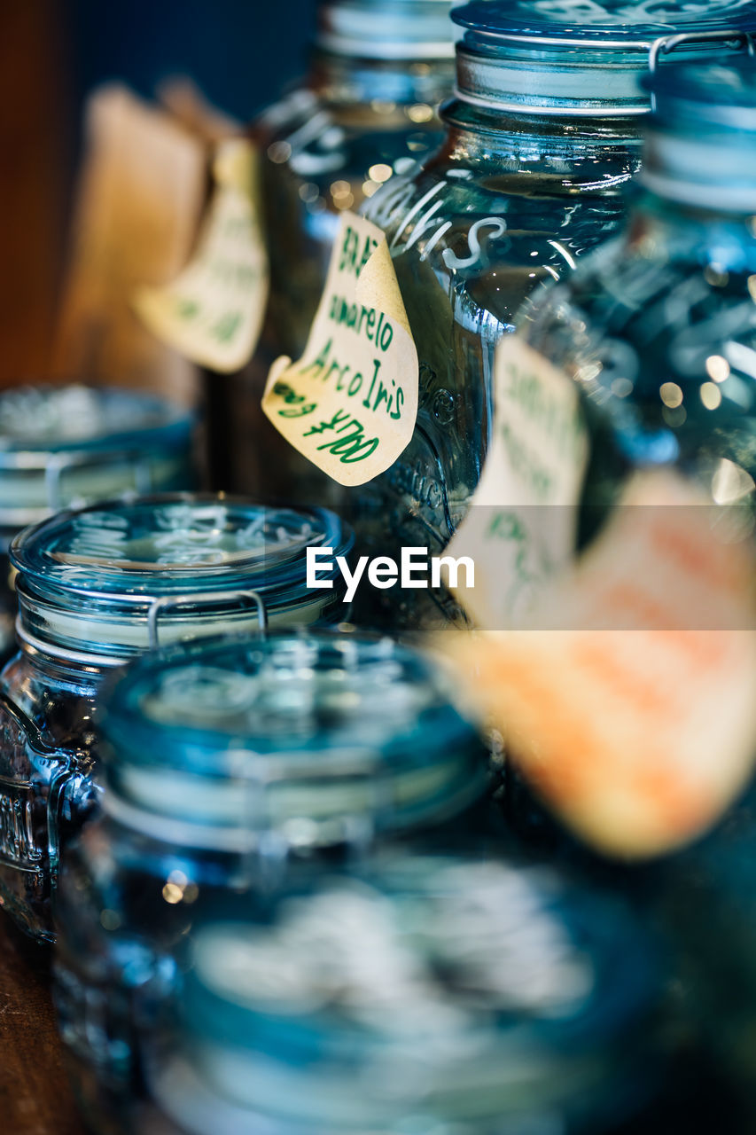 blue, selective focus, water, bottle, alcoholic beverage, container, indoors, drink, food and drink, close-up, glass, alcohol, party, jar