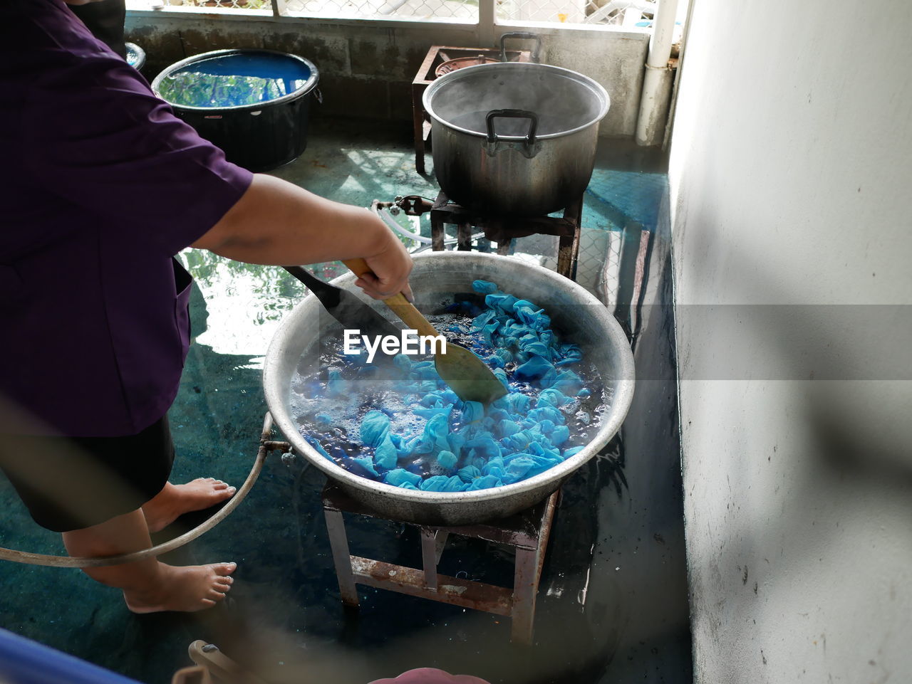 High angle view of man boiling textile