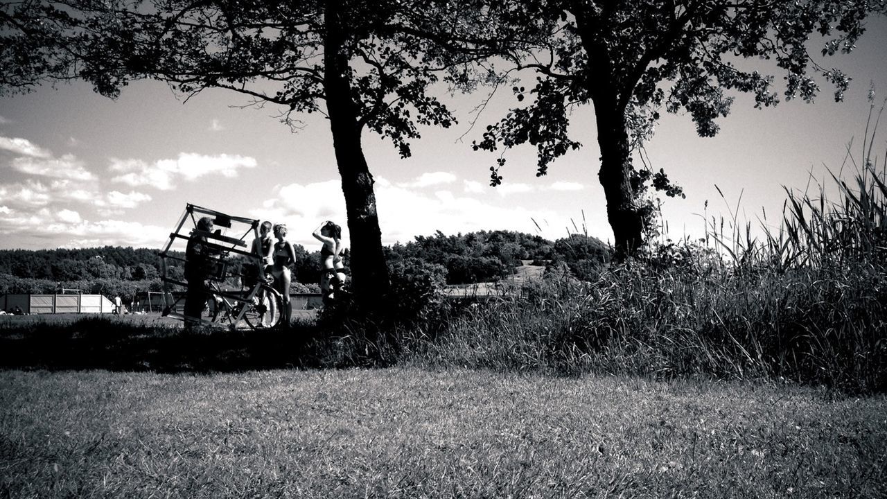 People standing under tree