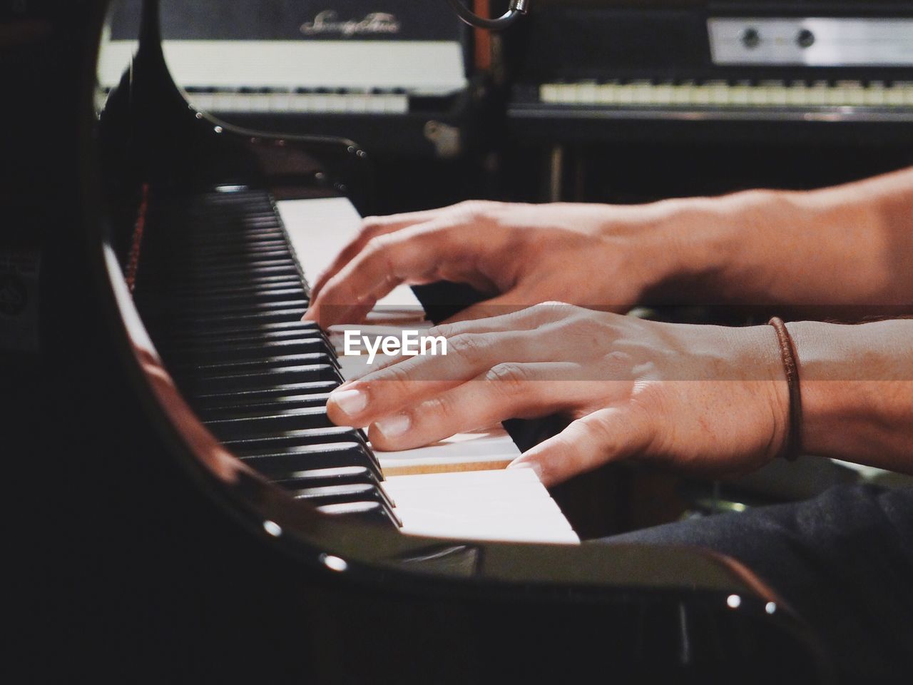 Cropped image of man playing piano