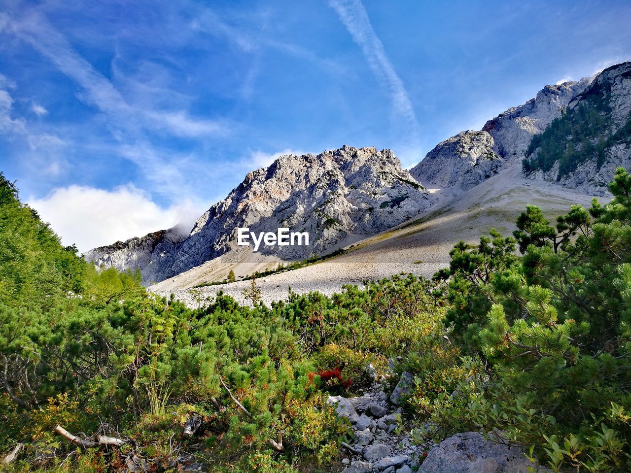 Scenic view of land and mountains against sky