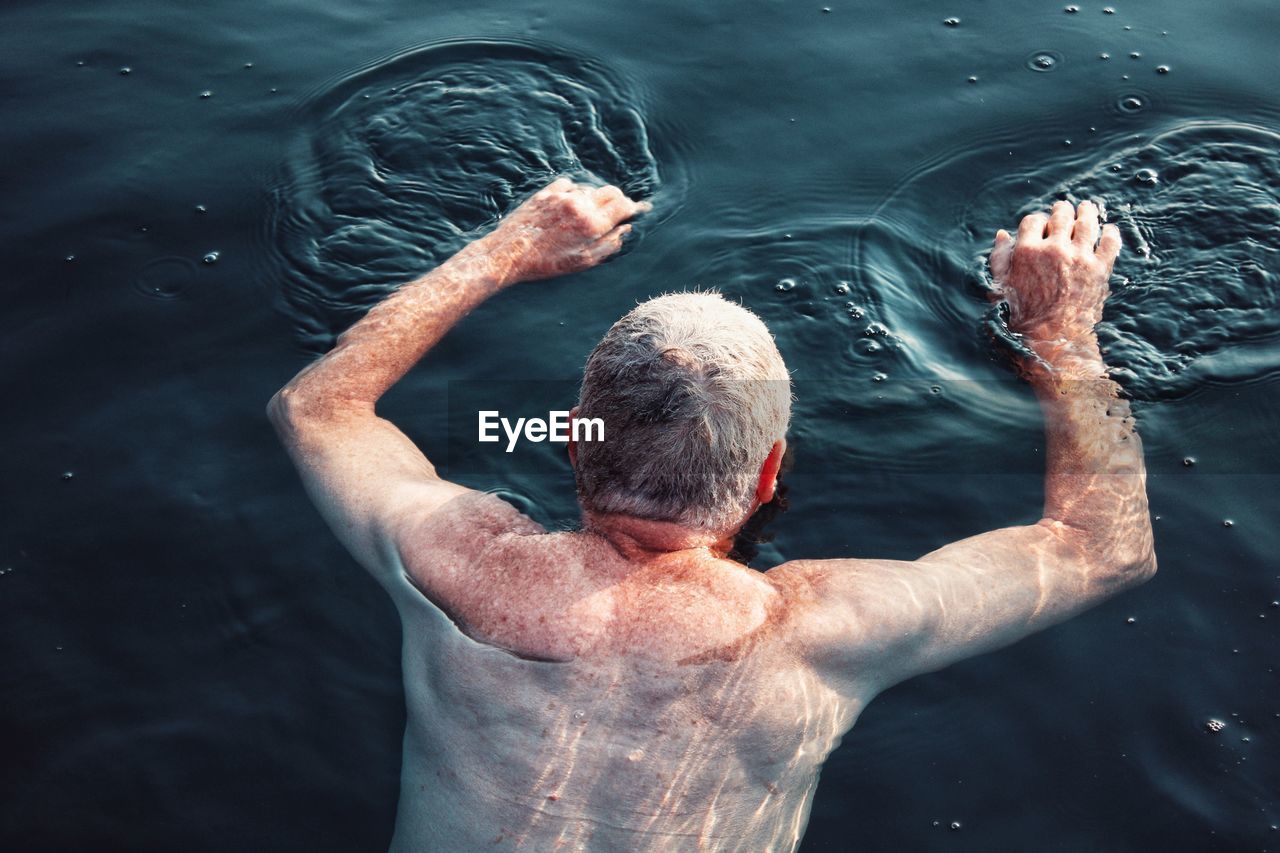 High angle view of man swimming in lake