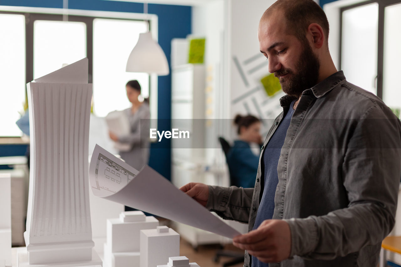 side view of young man working at office