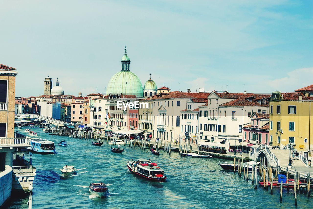 BOATS IN CANAL BY BUILDINGS IN CITY