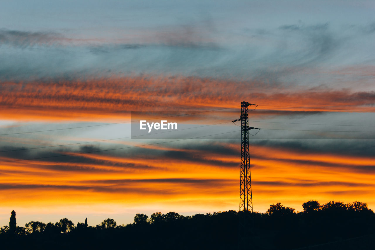 SILHOUETTE ELECTRICITY PYLON AGAINST SKY DURING SUNSET