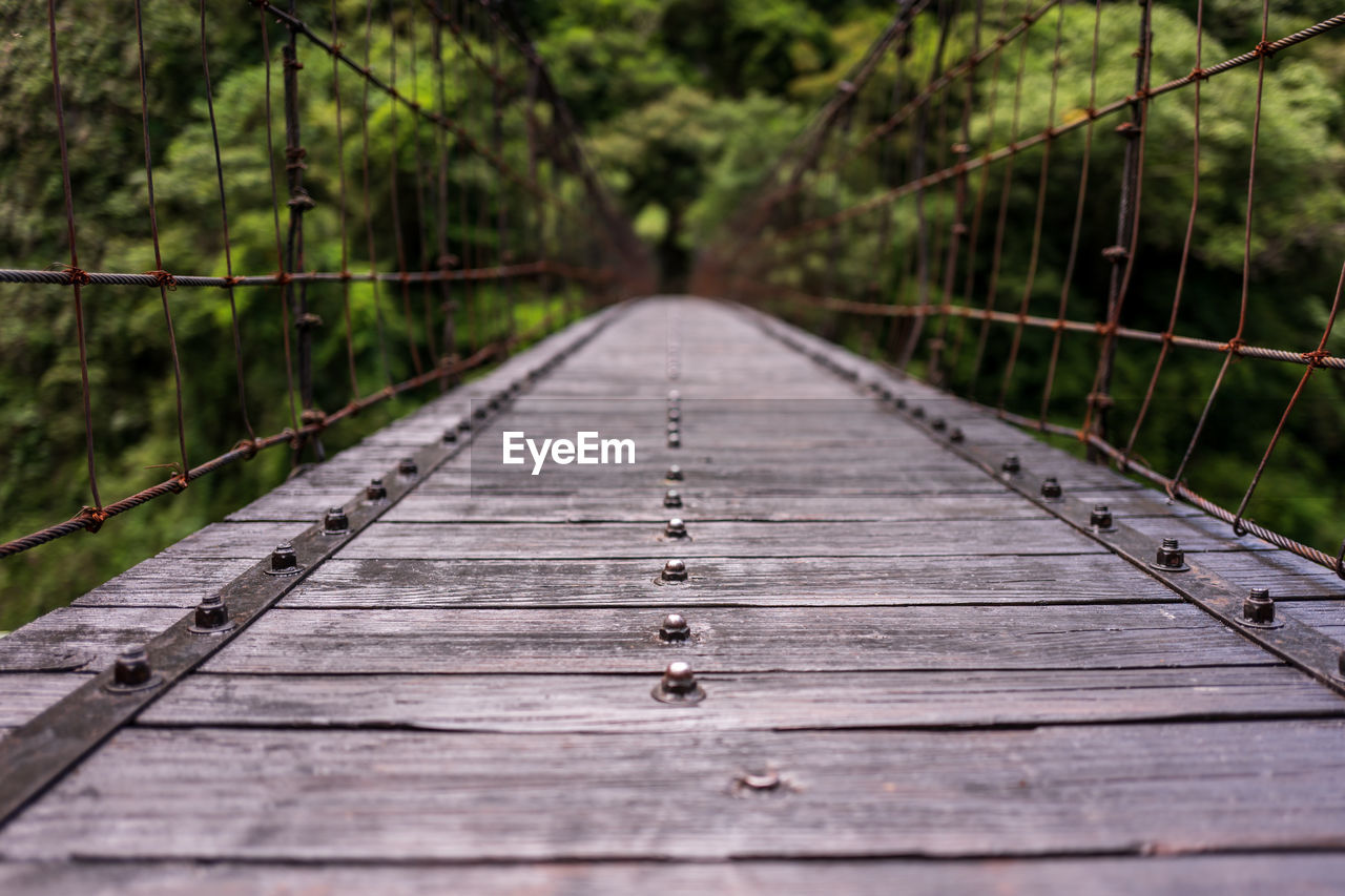 Surface level of wooden footbridge in forest