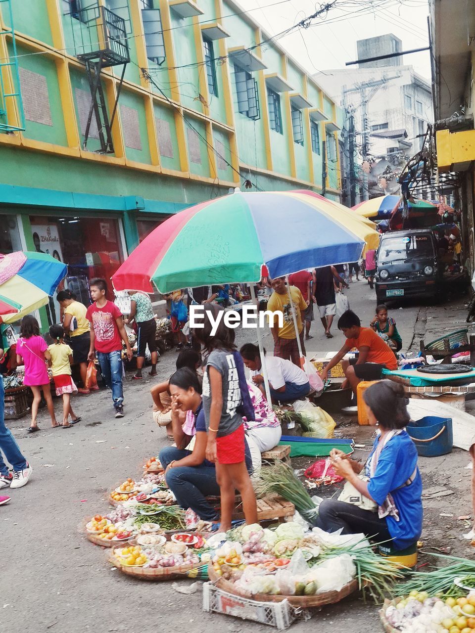 PEOPLE IN MARKET STALL