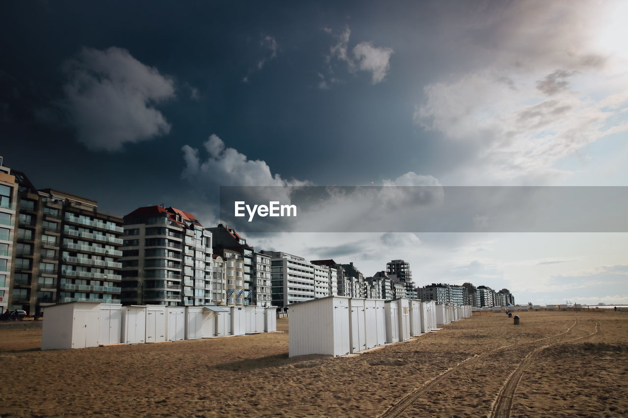 Low angle view of buildings on beach against sky