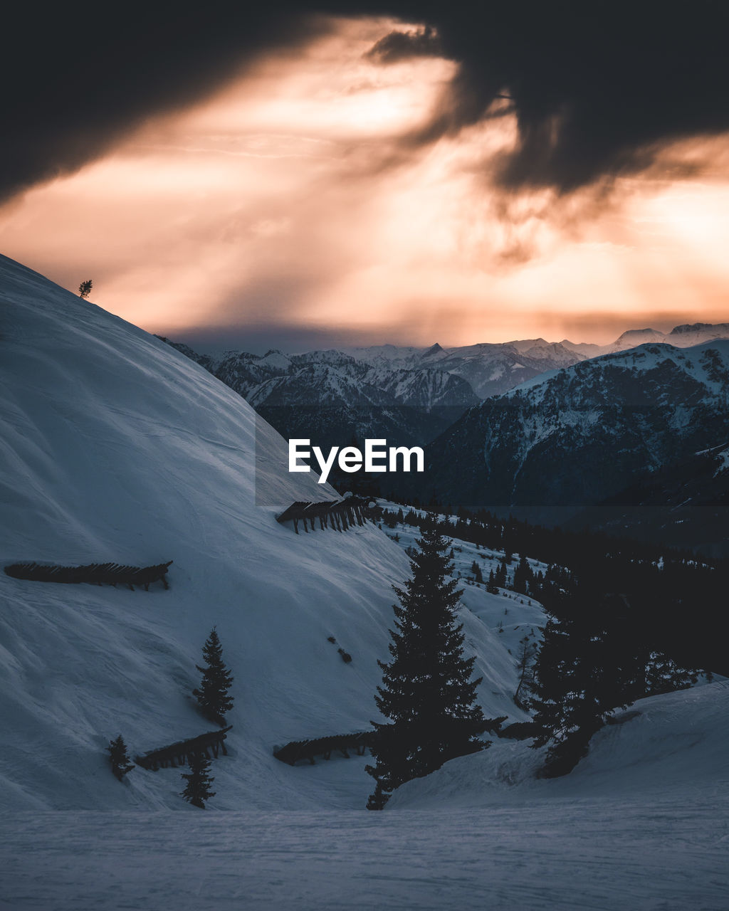 Scenic view of snowcapped mountains against sky during sunset